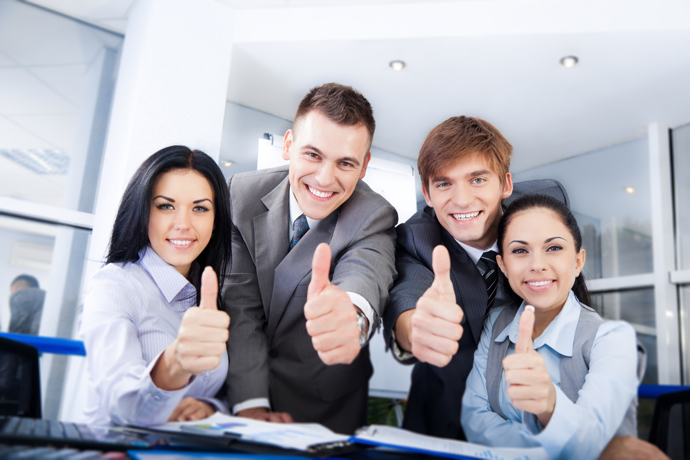 Group of individuals giving thumbs up.