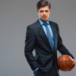 Businessman holding basketball